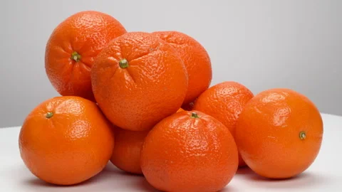 Close-up Pile of Ripe Oranges Rotating on White Background Studio Shot 4K Stock Footage 319454204
