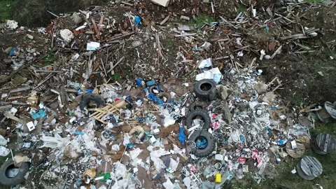 CLOSE UP: Piles of plastic construction debris lie near the illegal dump road Vídeos de archivo 150829924