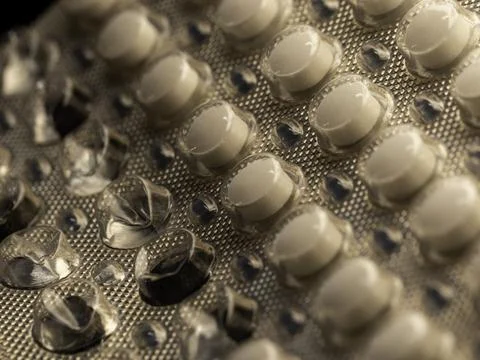 Close-up of pill blister pack, rows of white capsules Stock Photos