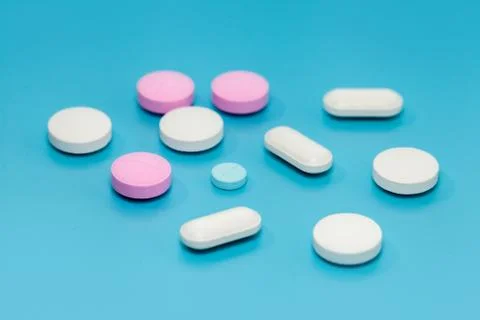 Close up of pill on blue background Stock Photos