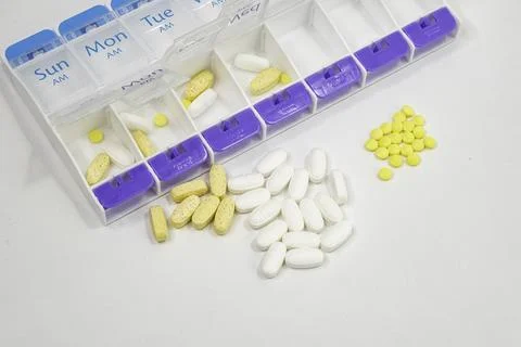 A close up of a pill box partially filled. Stock Photos