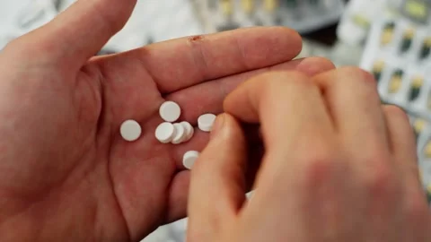 Close-up of a pill in a man's hand. Video stock 278315684