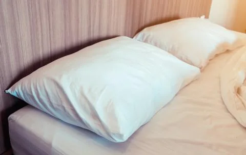 Close up of pillows on the bed after wake up with soft light morning Stock Photos