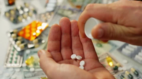 Close-Up of Pills Being Poured from a Bottle into Hand Video stock 278829381