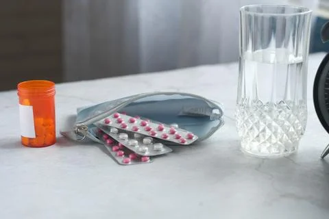 Close up of pills of blister pack in a small bag on table at home Stock Photos