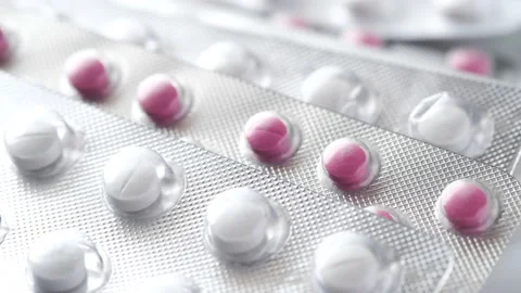 Close up of pills of blister pack on white Stock Footage 154437331