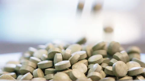 Close up pills dropping white background side shot slow motion 100fps Stock-Footage 156168464