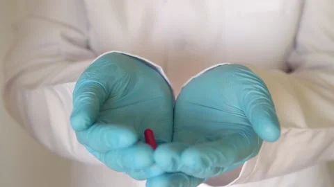 Close-up pills fall into the gloved hands. Close-up. Stock Footage 150380543