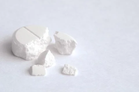 Close-up pills lying on the table Stock Photos