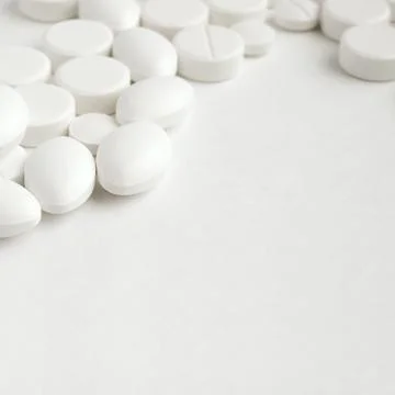 Close-up pills lying on the table Stock Photos