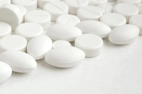 Close-up pills lying on the table Stock Photos