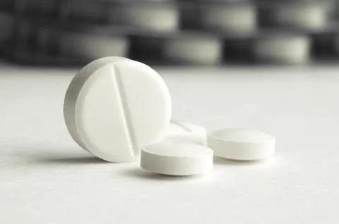 Close-up pills lying on the table Stock Photos
