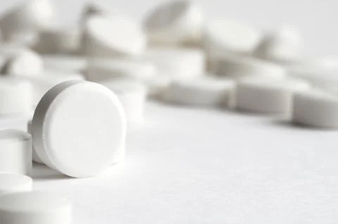 Close-up pills lying on the table Stock Photos