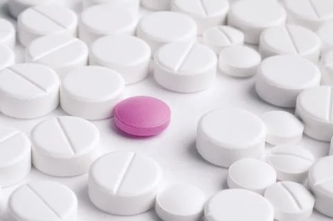 Close-up pills lying on the table Stock Photos