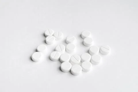 Close-up pills lying on the table Stock Photos