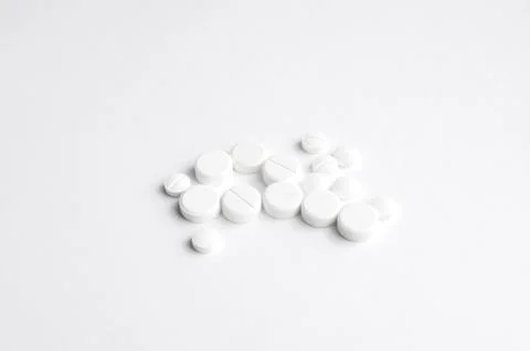 Close-up pills lying on the table Stock Photos