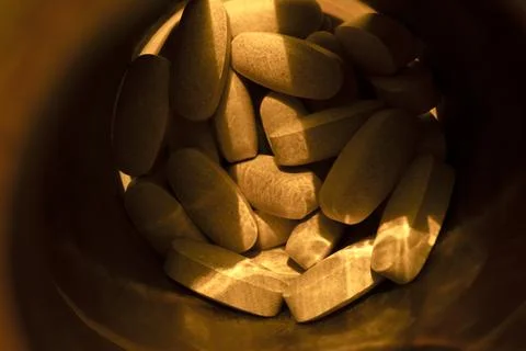 Close-up pills lying on the table Stock Photos