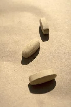 Close-up pills lying on the table Stock Photos
