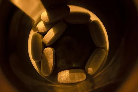 Close-up pills lying on the table Stock Photos
