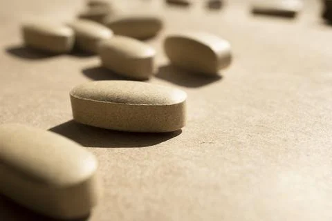 Close-up pills lying on the table Stock Photos
