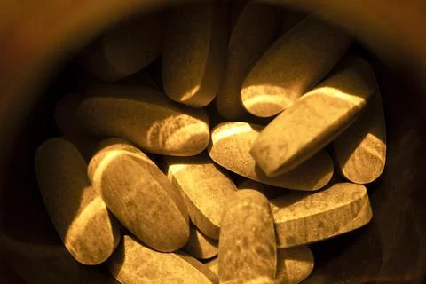 Close-up pills lying on the table Stock Photos