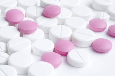 Close-up pills lying on the table Stock Photos