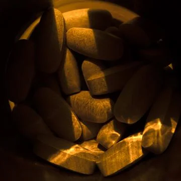 Close-up pills lying on the table Stock Photos