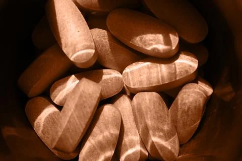 Close-up pills lying on the table Stock Photos
