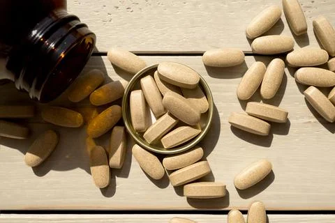 Close-up pills lying on the table Stock Photos