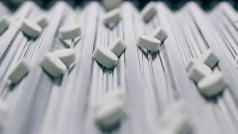 Close up of pills on the moving transporter Stock Footage 159478437