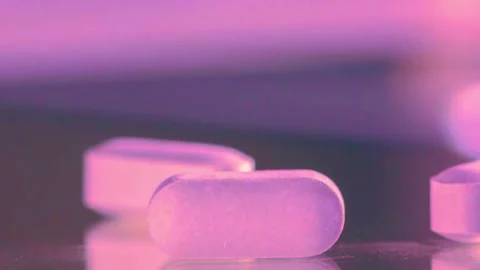 Close up on pills with soft purple lighting and reflections Stock-Footage 341970171