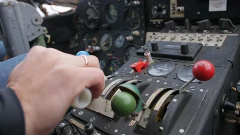 A close-up of a pilot's hand with a wedding ring grasping the thrust lever. Video stock 200786376