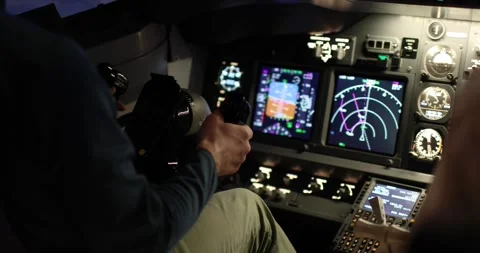 Close-up of the pilot's hands holding the helm of an aircraft. Illuminated Stock Footage 241819156