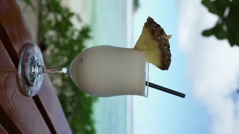 Close-up of a Pina Colada cocktail on the background of the ocean in the tropics Stock Footage 154807638