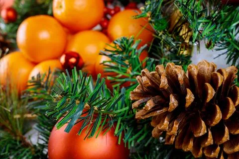 Close up of pine cone with oranges. Stock Photos