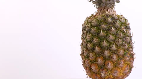 Close Up of Pineapple Rotating On A White Background Video stock 130229412