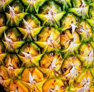 Close up pineapple skin surface showing tropical fruit texture and organic .. Stock Photos