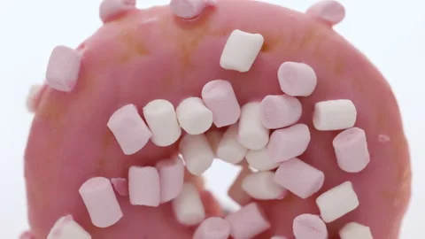 Close up pink and white marshmallows on pink donut food light sweet dessert Stock Footage 194833670