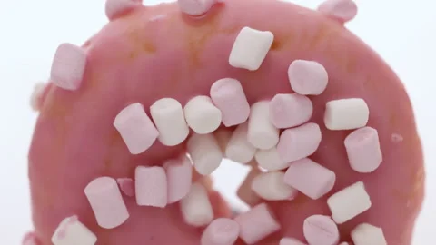 Close up pink and white mini marshmallows on pink donut food light sweet dessert Stock-Footage 194838156