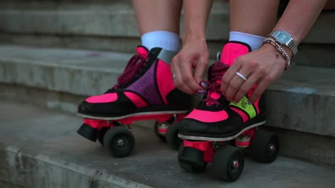 Close-up of pink bright disco retro roller quads on the street. Urban city. Stock Footage 196916022