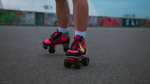 Close-up of pink bright disco retro roller quads on the street. Urban city. Stock Footage 196916336