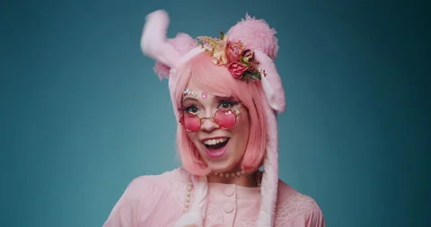 Close up of pink cute candy anime girl with rabbit ears and pink sunglasses make Video stock 156897359