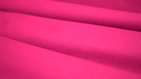 Close-up of a pink fabric folded in several layers. fuchsia color Stock Footage 219755211