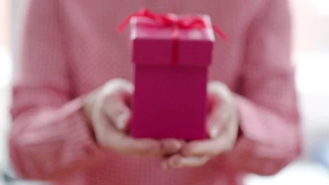 Close up of pink gift box with red ribbon in womans hands Stock Footage 71612854
