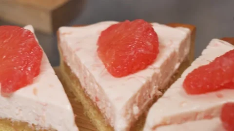 Close-up of Pink Grapefruit Mousse Pie Slices with Fresh Citrus Garnish Stock Footage 337751257