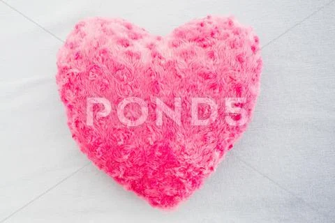 Close up of a pink heart shaped pillow Stock Photos