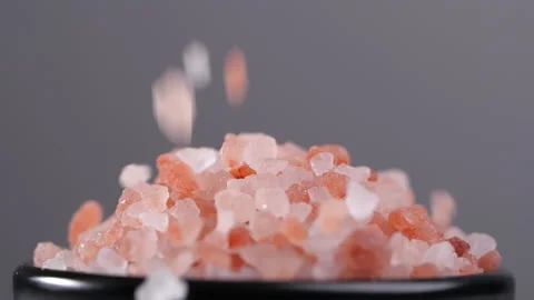 Close-up of pink himalayan salt falling in slow motion Stock Footage 137216372