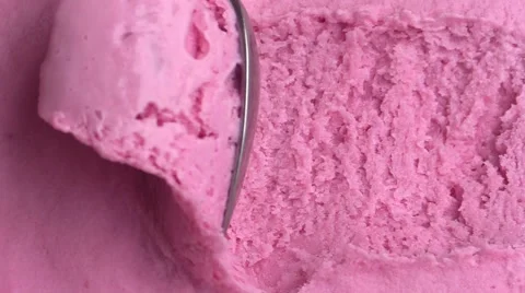 Close up of pink ice cream being scooped Stock Footage
