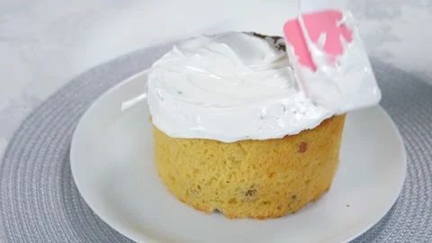 Close-up.Pink kitchen spatula we spread the glaze on delicious Orthodox Easter Stock Footage 169649505