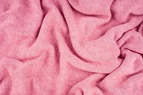 Close up pink knitted pullover background. Top view. Stock Photos